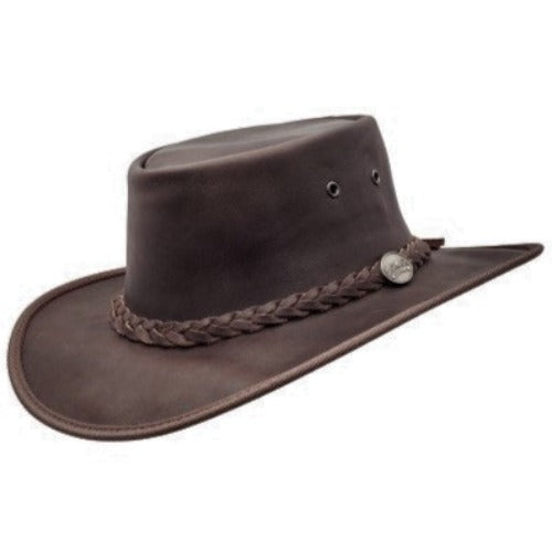 A brown cowhide leather hat with a foldable design, featuring a braided band and a metal ornament on the crown.